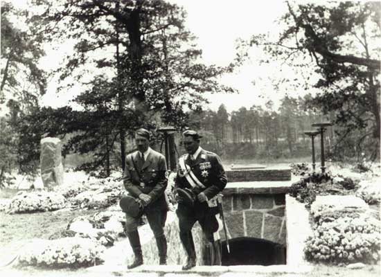 Staff greet Hitler, Göring, emerging from Carin's new crypt at Carinhall, June 1934